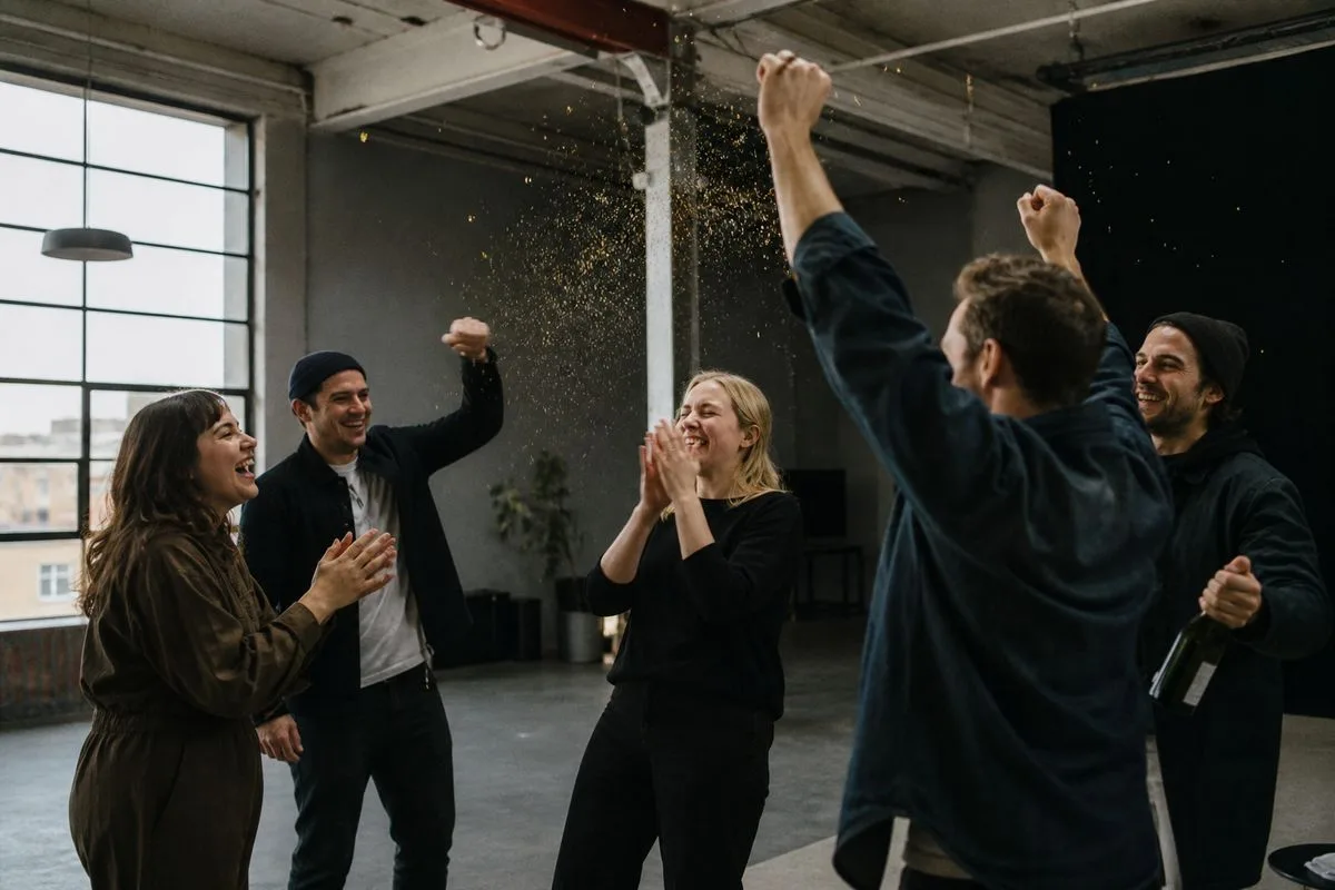 Employees celebrating in a modern Gateshead production studio