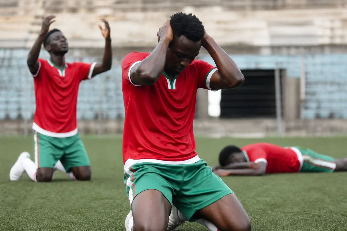Burundi football players showing frustration on the pitch