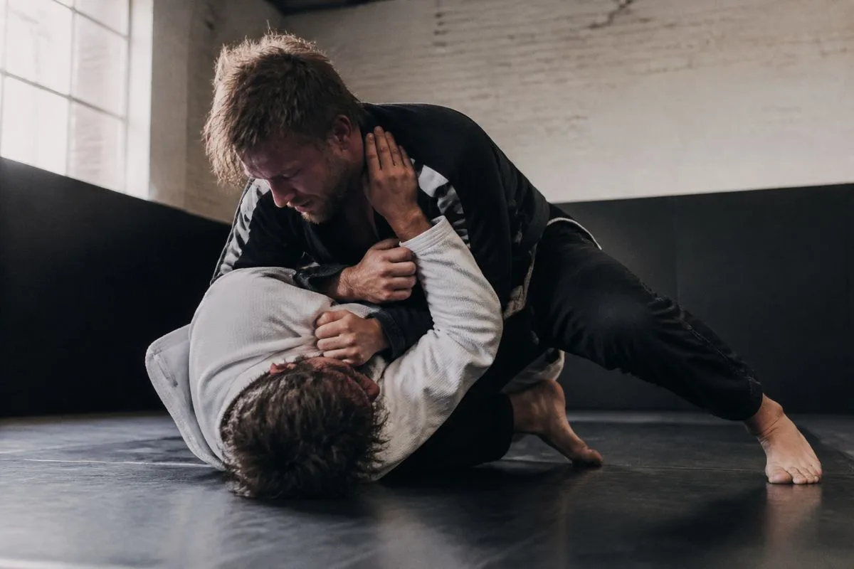 Two fighters grappling intensely during a BJJ match in Sheffield gym