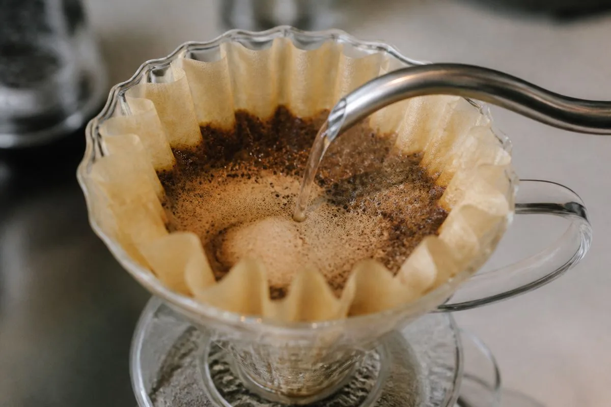 Close-up of a Kalita Wave 185 coffee dripper brewing coffee.