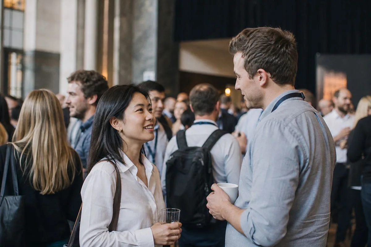 Attendees networking at a bustling e-commerce conference hall