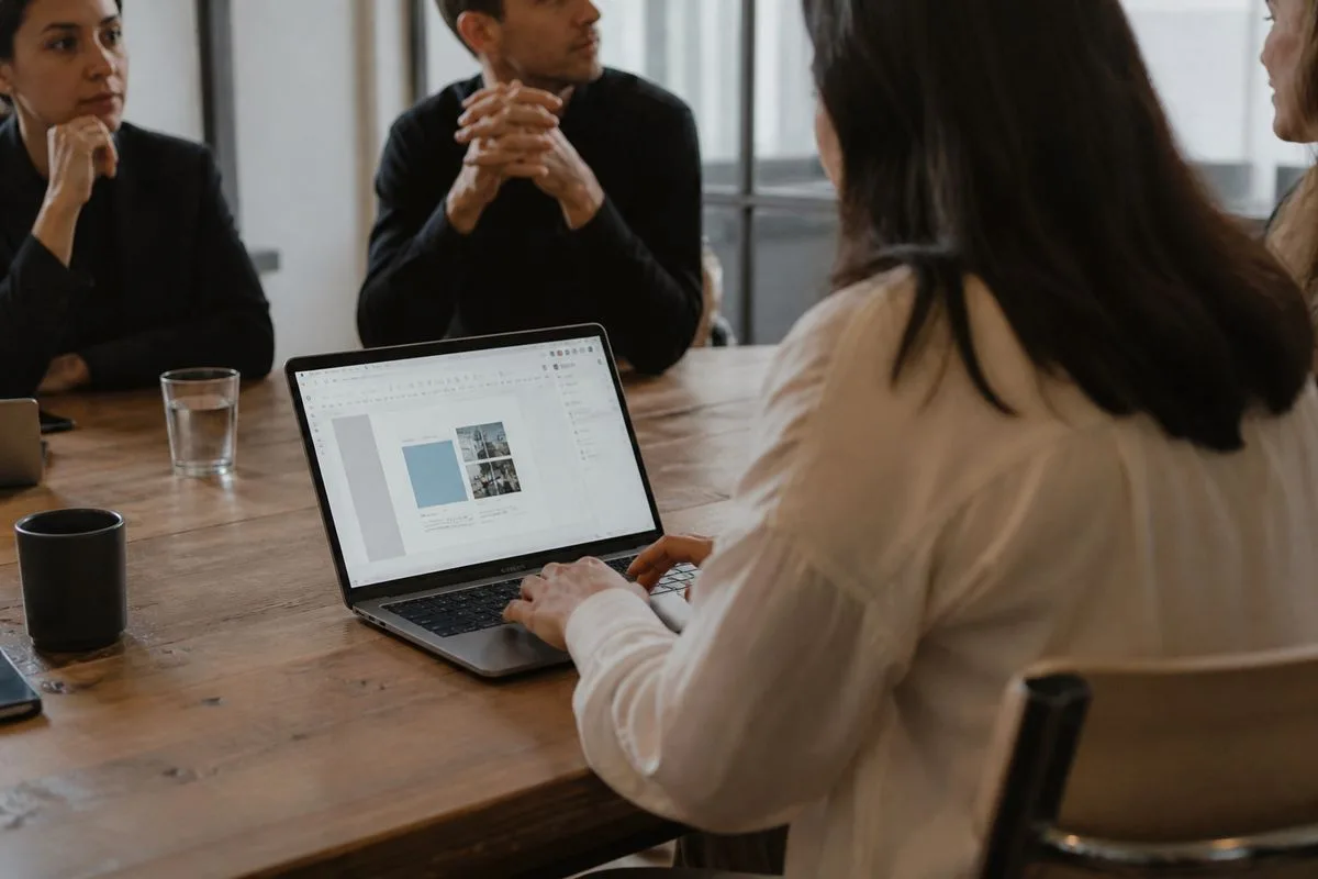 A professional using Google Workspace on a laptop during a meeting