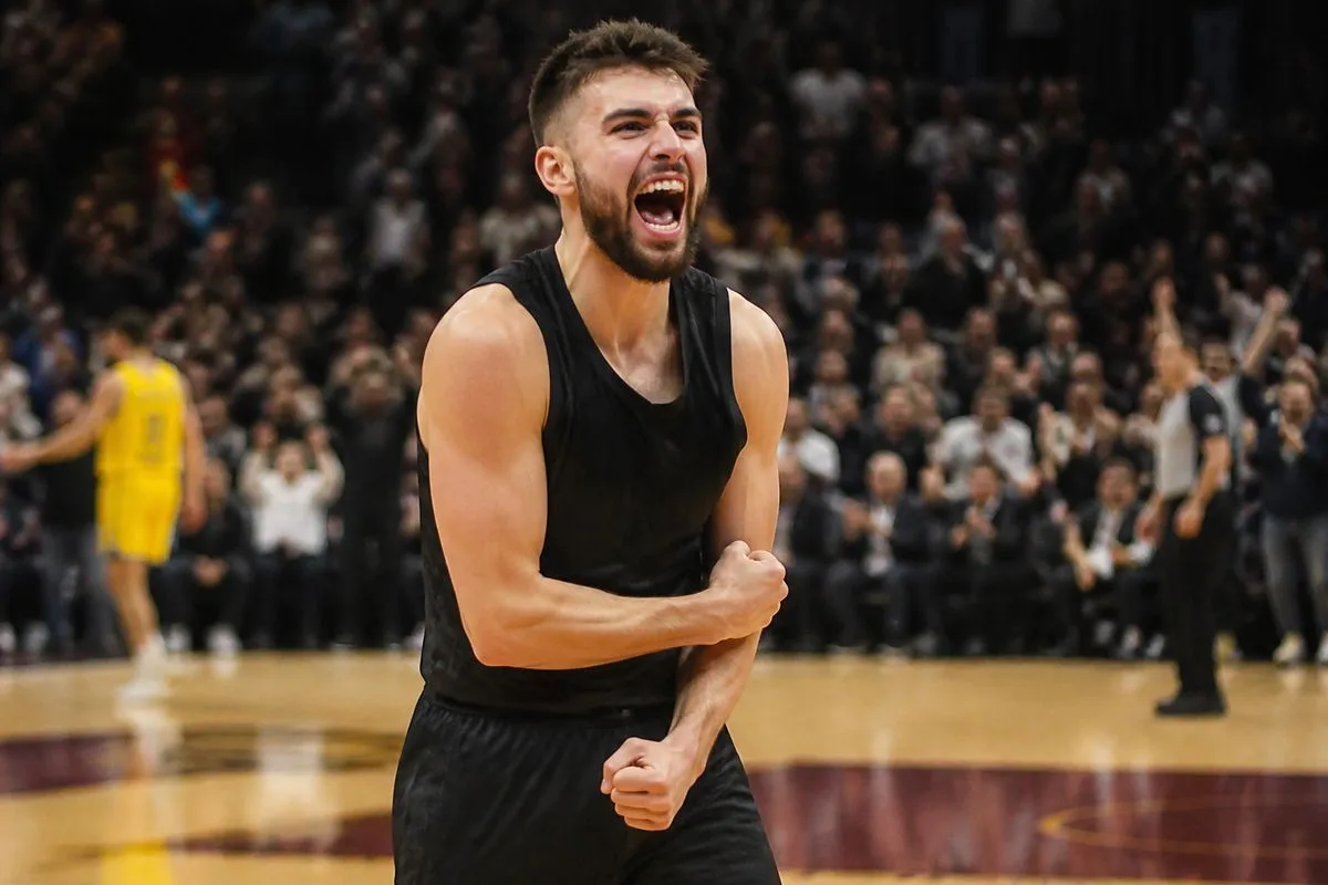 Ty Jerome celebrating on the court after game-winning shot