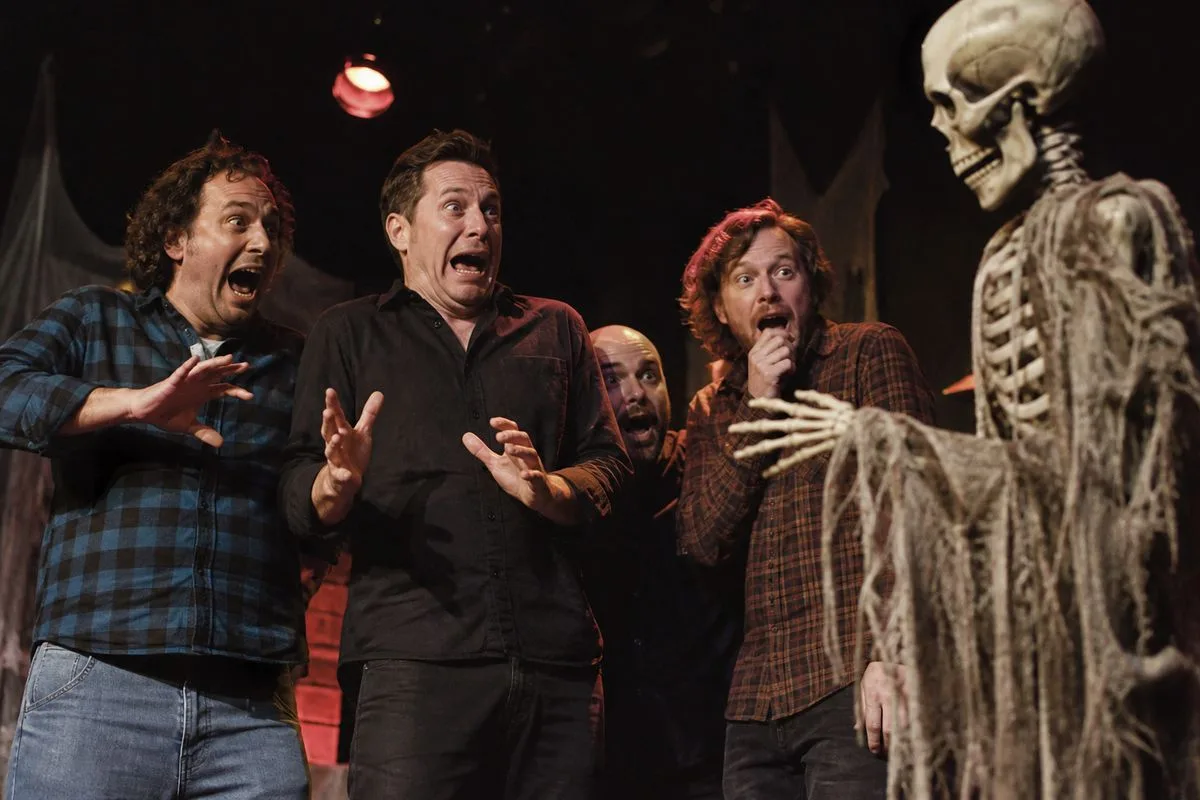 Comedians reacting to spooky Halloween props on stage