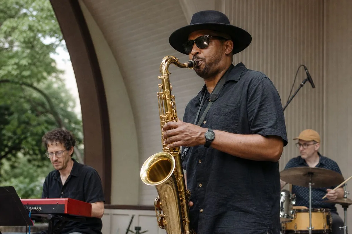 Musicians performing at an outdoor community bandshell event