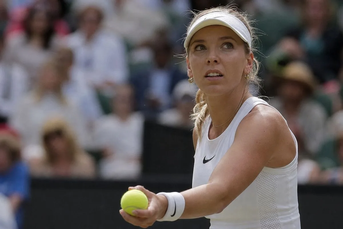 Katie Boulter preparing to serve during a tense tennis match.