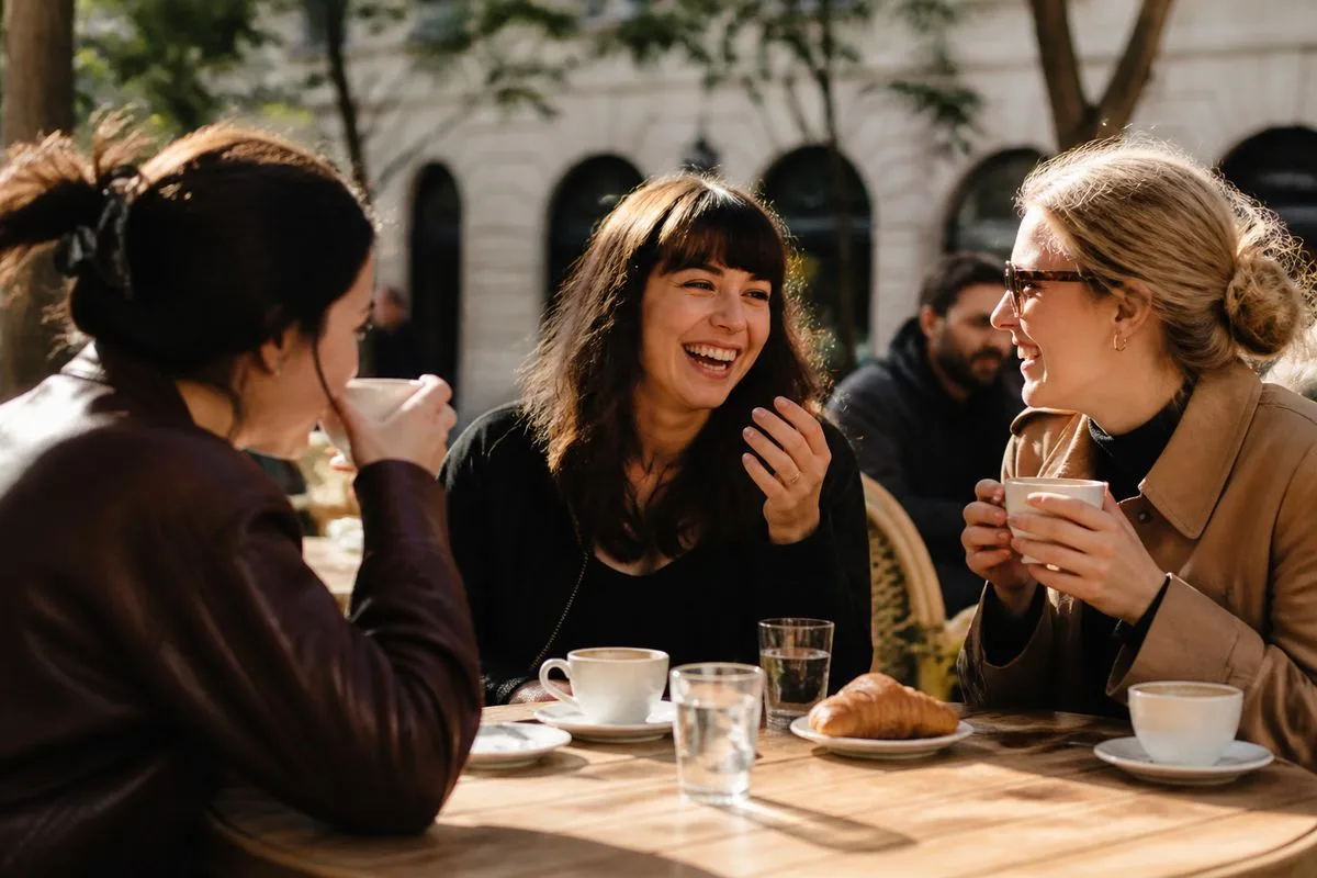 People enjoying coffee together at an outdoor café terrace