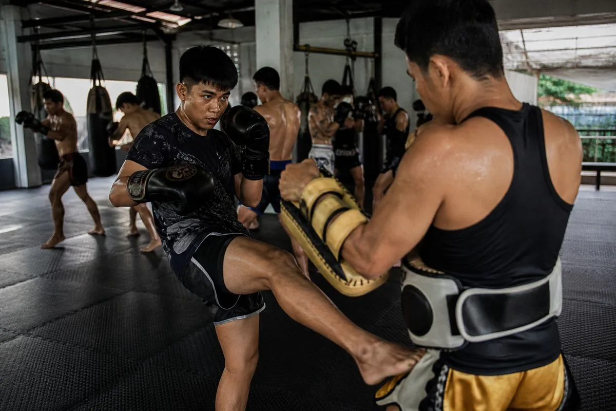 A Muay Thai class in session at a modern gym.