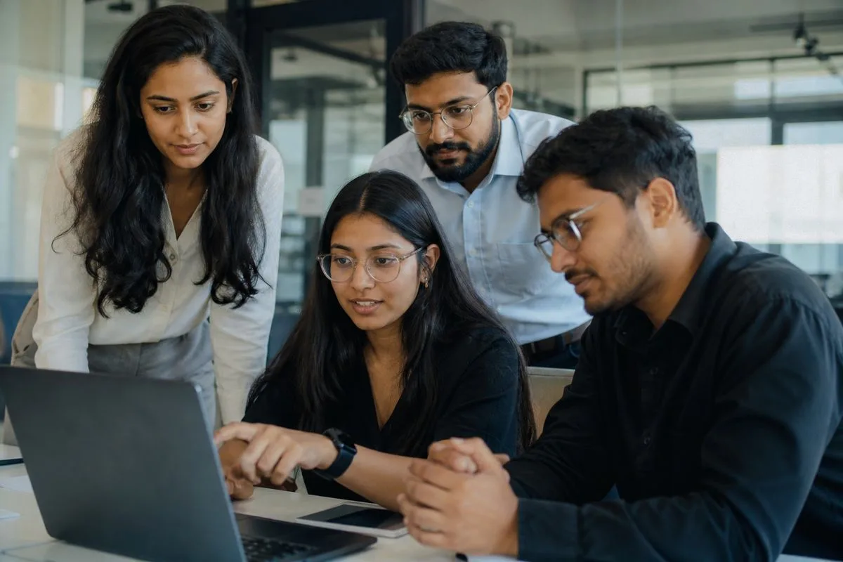 Cognizant team collaborating over AI project in modern office