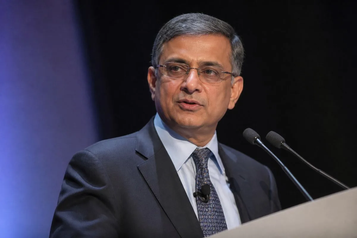 Sanjay Mehrotra speaking at a corporate event podium