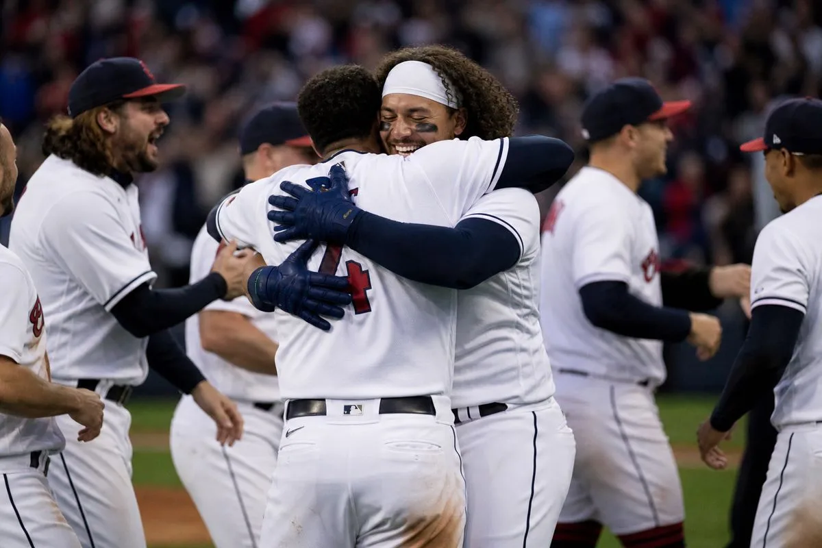 Cleveland Guardians players celebrating on the field after a game.