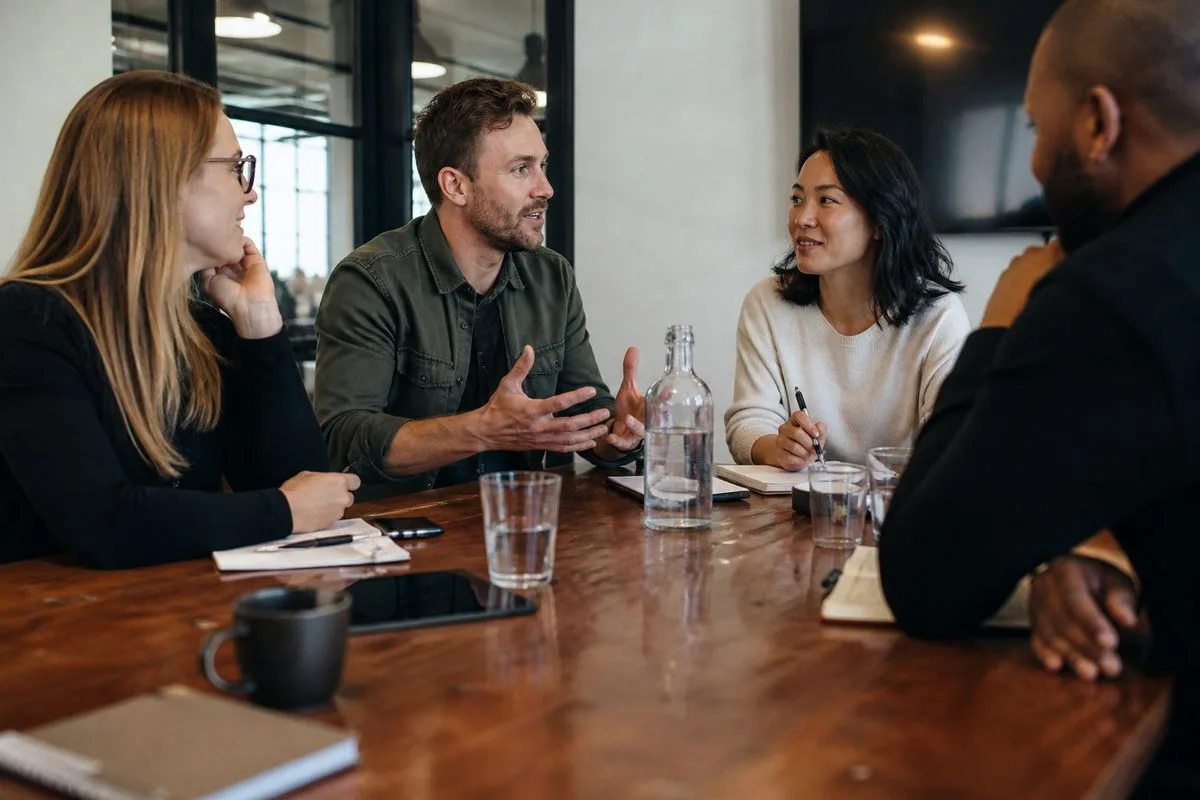A tech sales team collaborating around a conference table