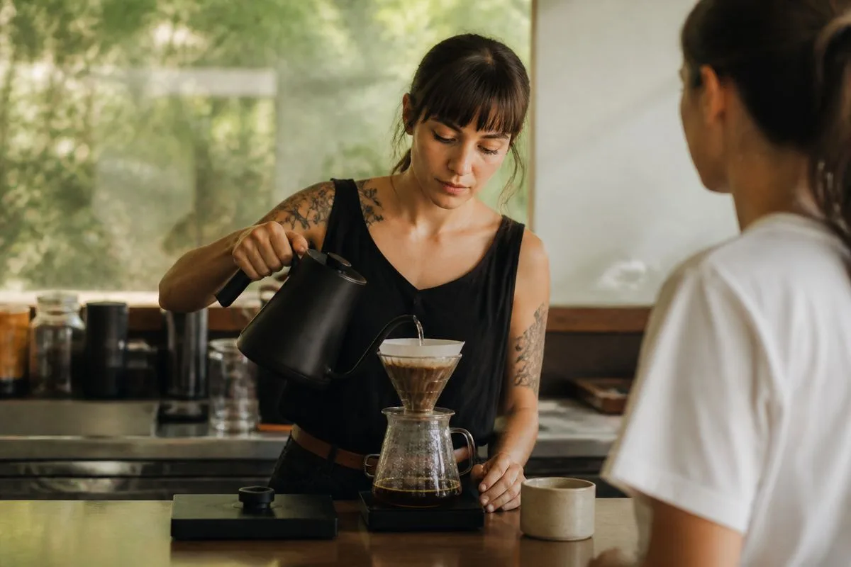 A barista preparing specialty coffee for a club member.