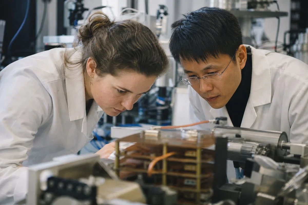 Scientists examining layered magnetic materials in a lab setting