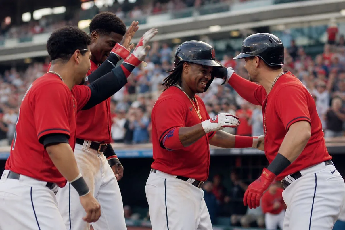 Cleveland Guardians players celebrating a home run on the field