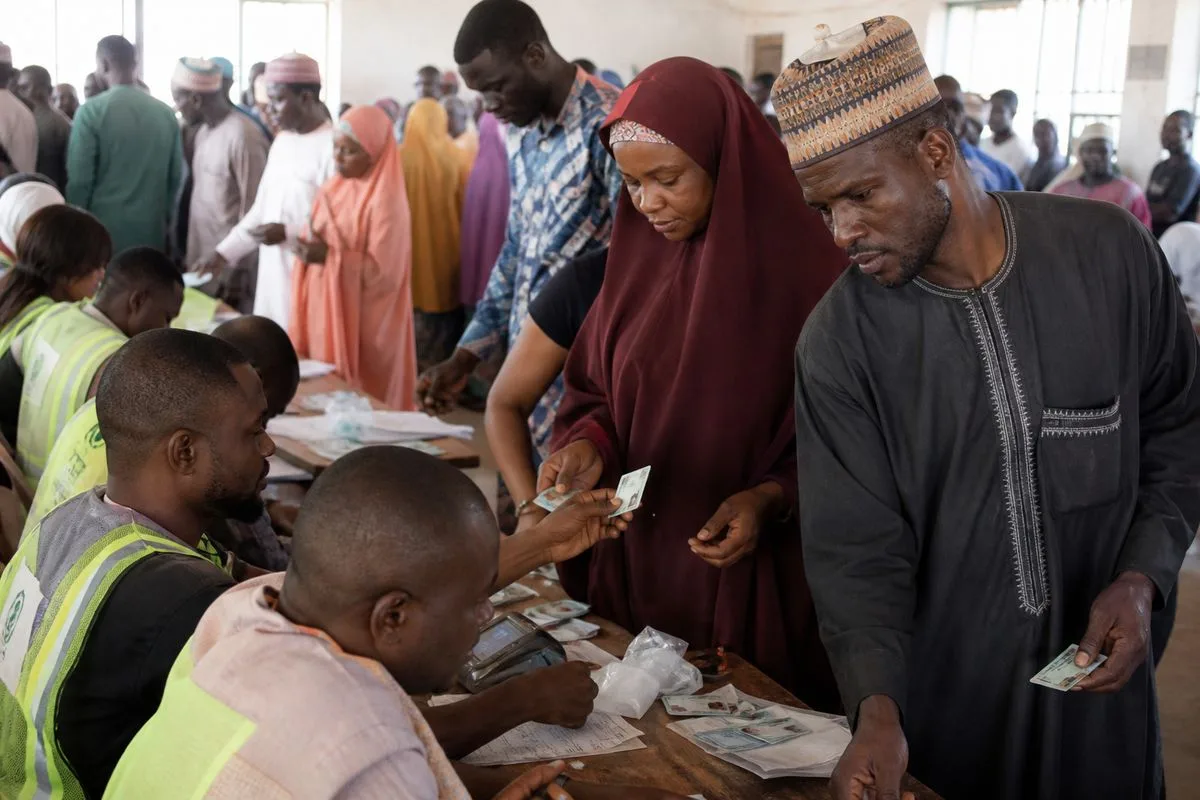 Voters collecting PVC cards at a crowded registration center