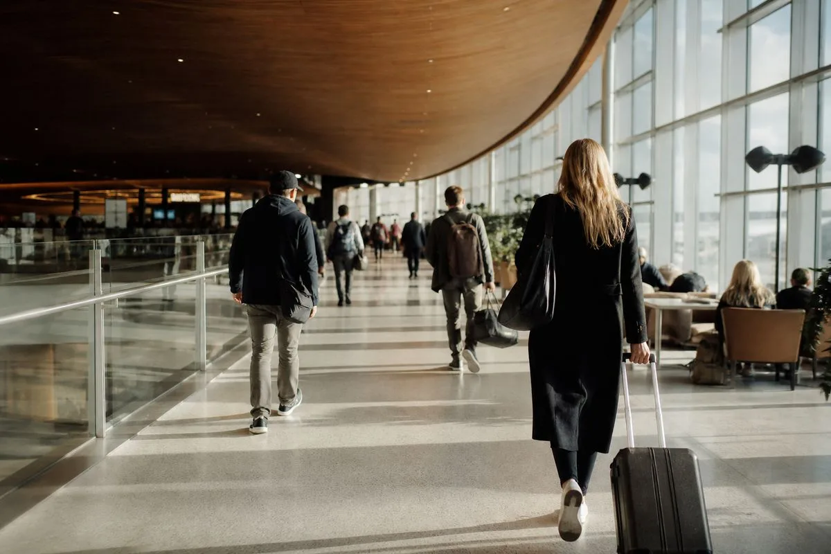 Passengers walking through a modernized airport terminal lounge