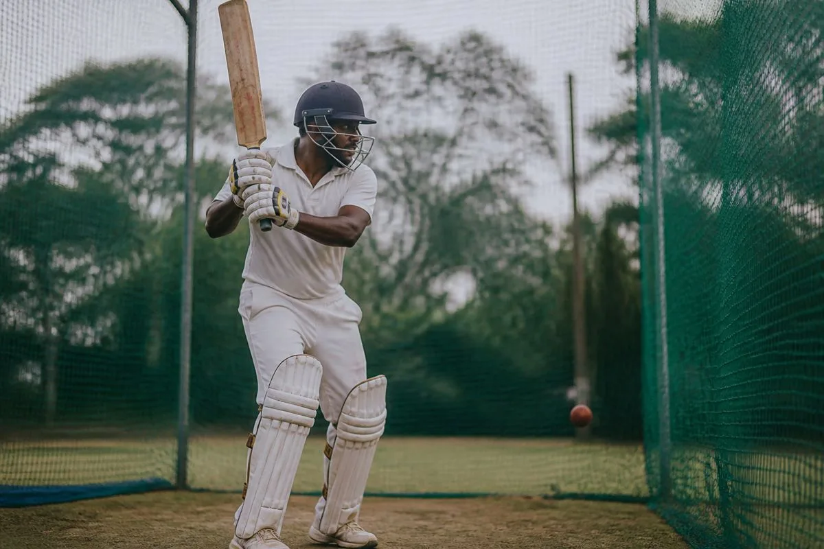 Cricketer practicing batting at Queen’s Park Cricket Club.