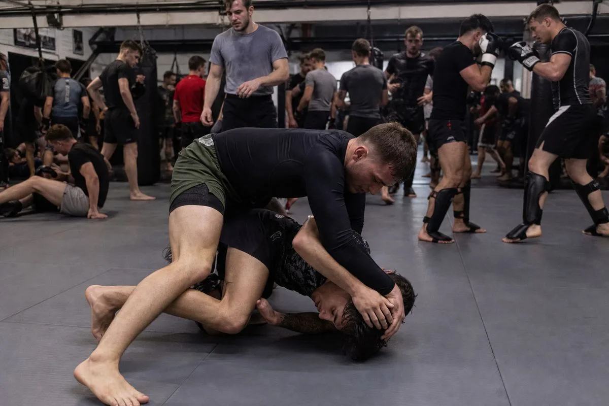 Fighters warming up in a crowded MMA gym in Sheffield