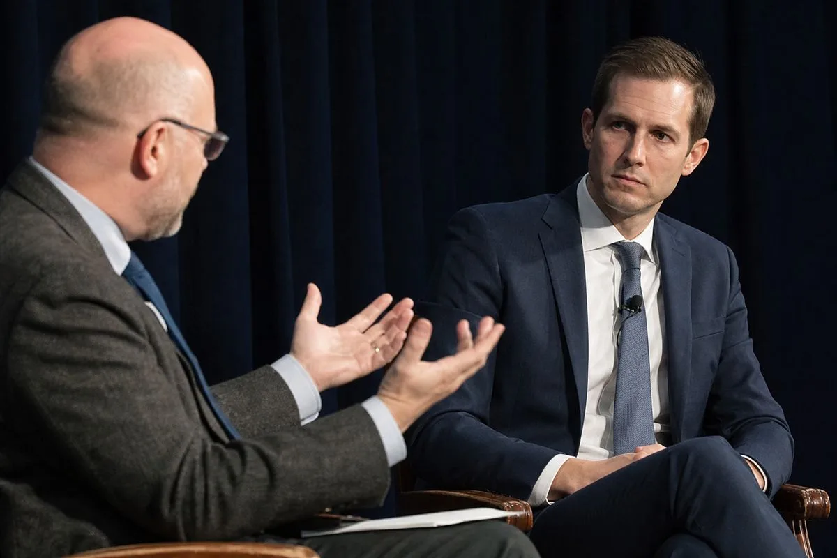 Professor Maxwell Palmer and Congressman Jake Auchincloss debating at a forum