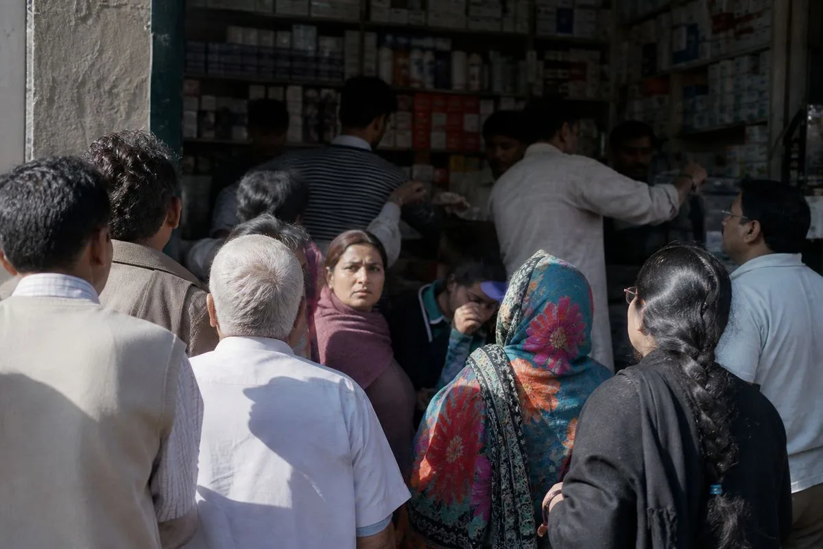Shoppers gathered outside a crowded pharmacy entrance