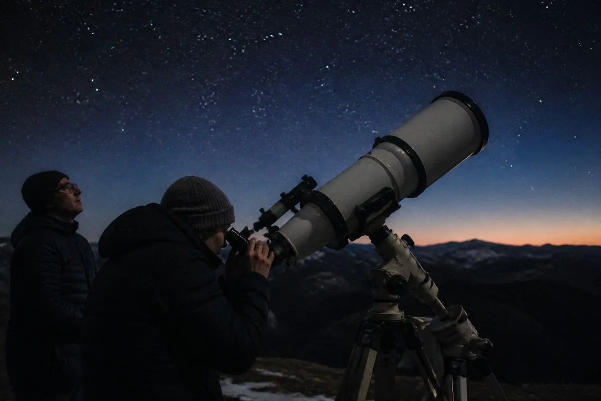Astronomers observing white dwarf stars through a telescope at night