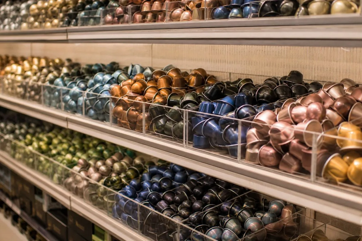 Shelves stocked with colorful Nespresso coffee pods in a store aisle