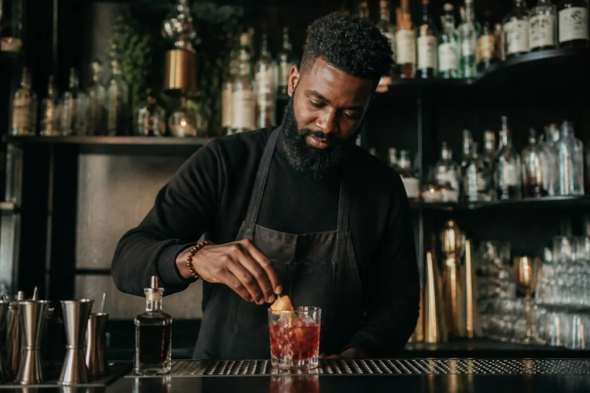 Bartender crafting a cocktail at Side Hustle Lounge, Detroit