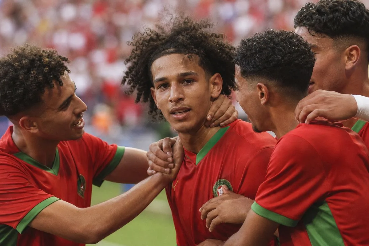 Bouaddi celebrating with Morocco teammates after a goal